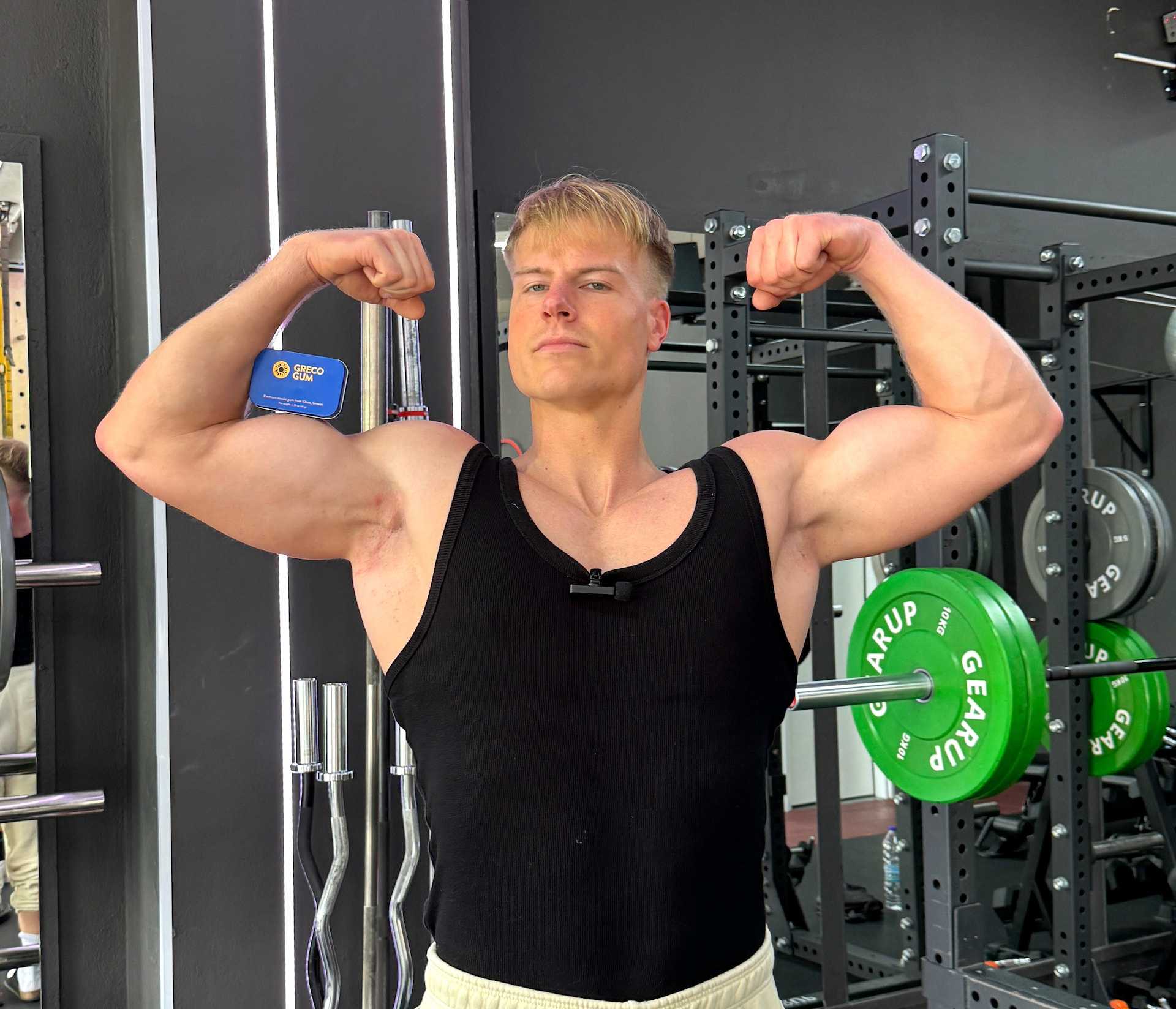 Fitness expert Marcel Schaar posing with Greco Gum tin inside a gym.